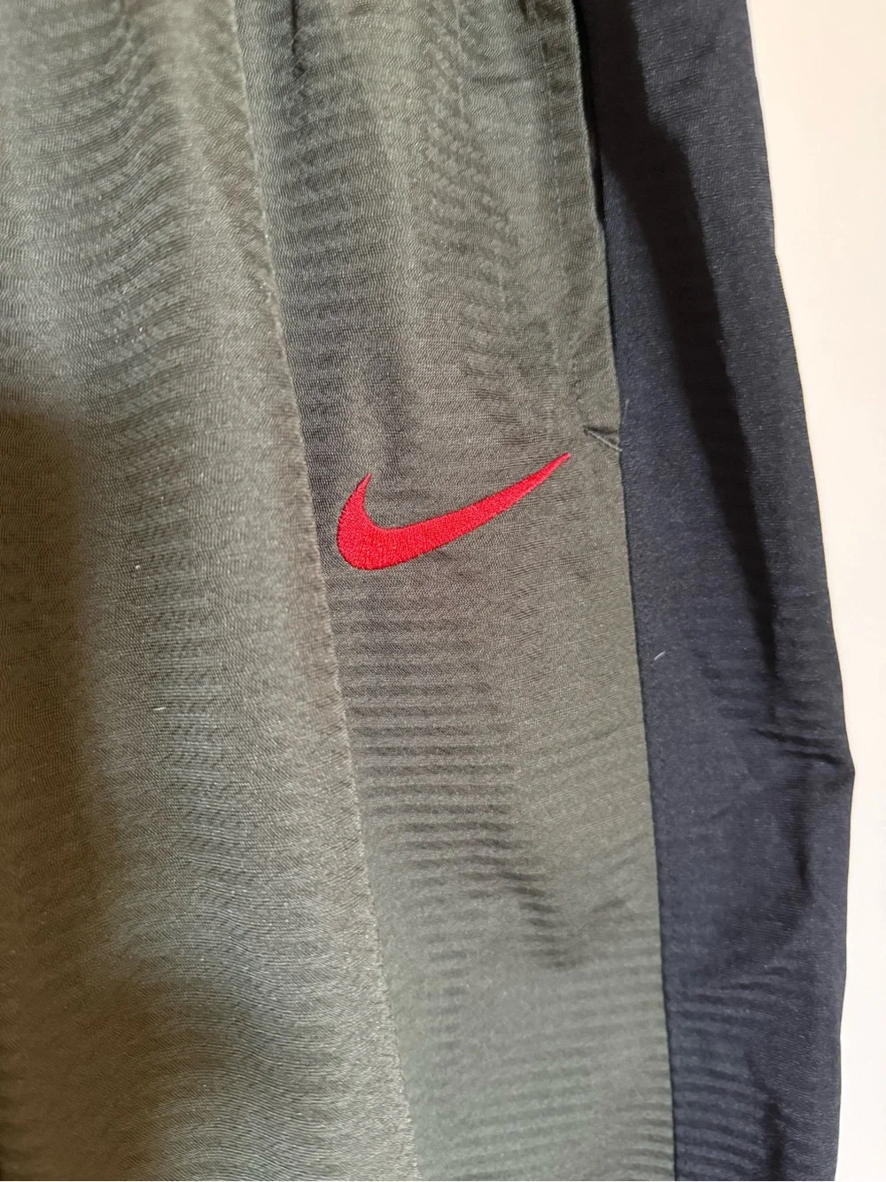 Nike Men's Olive Green Athletic Shorts with Black Panels and Red Swoosh